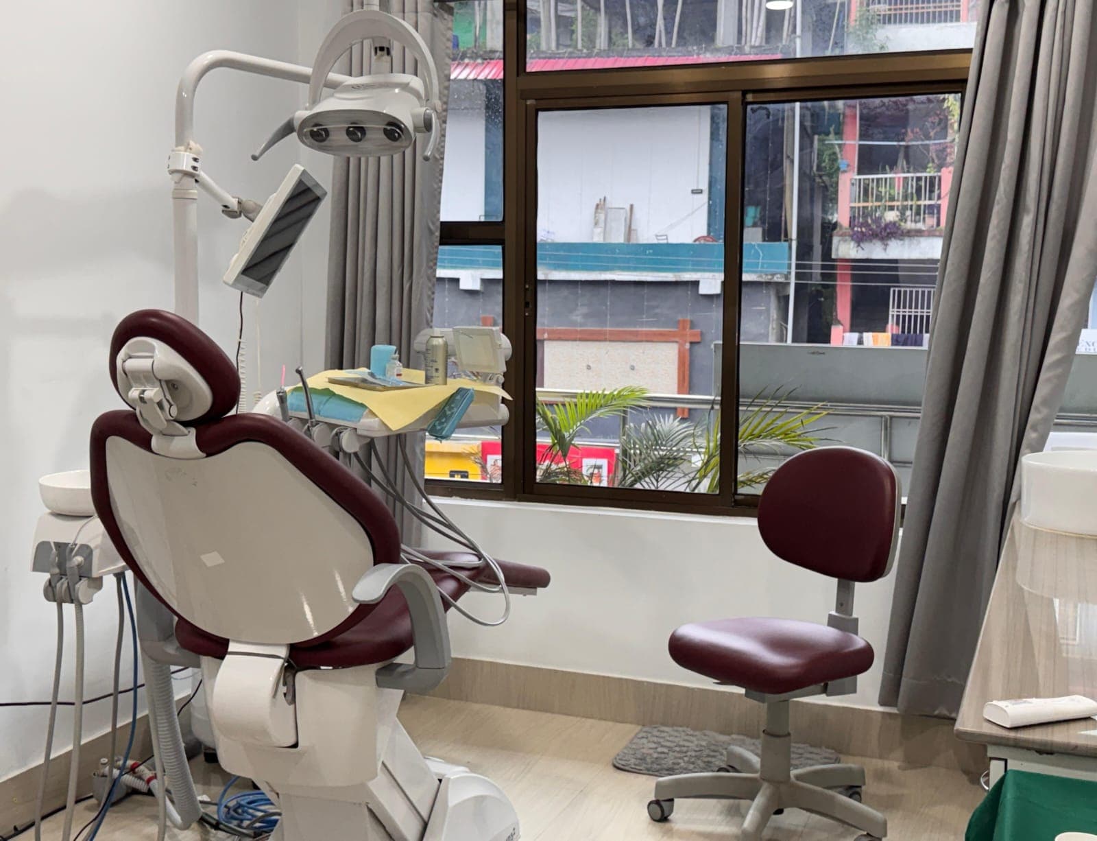 Bright dental treatment chair beside a window