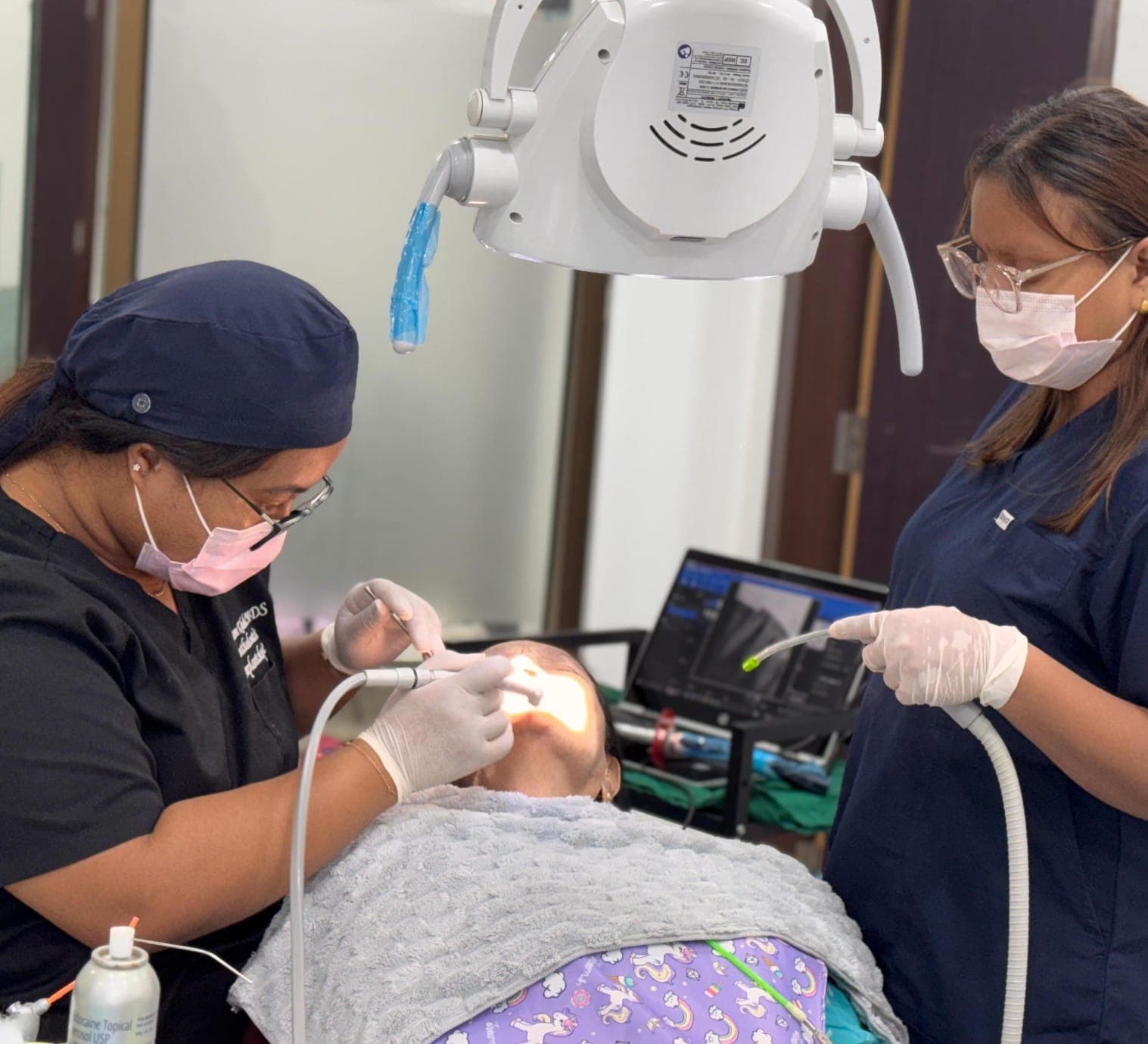 Dental team caring for a young patient